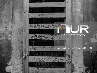 A door of shoop in the historic center of L'Aquila City, on January 11, 2014, severely damaged after the earthquake of April 6, 2009. (