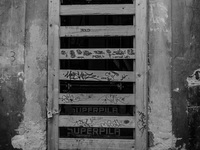 A door of shoop in the historic center of L'Aquila City, on January 11, 2014, severely damaged after the earthquake of April 6, 2009. (