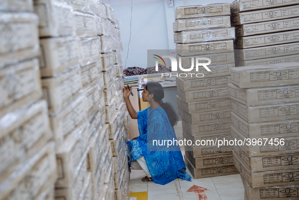 A woman working in the shipping department of a garment factory in Bangalore. Many of the workers emigrate from poor regions of the country,...