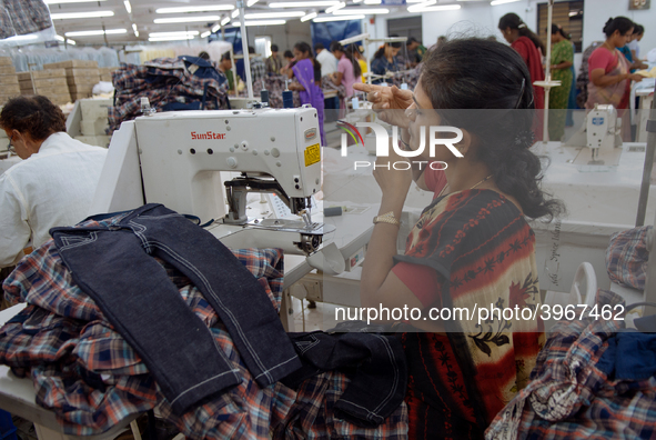 A seamstress making clothing at a garment factory in Bangalore. Many of the workers emigrate from poor regions of the country, making clothe...