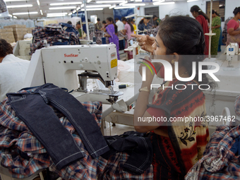 A seamstress making clothing at a garment factory in Bangalore. Many of the workers emigrate from poor regions of the country, making clothe...