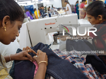 Seamstresses making clothing at a garment factory in Bangalore. Many of the workers emigrate from poor regions of the country, making clothe...