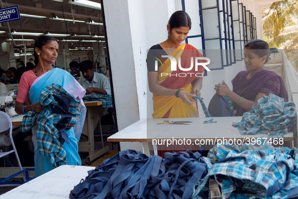 Workers making clothing at a garment factory in Bangalore. Many of the workers emigrate from poor regions of the country, making clothes to...