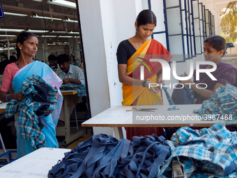 Workers making clothing at a garment factory in Bangalore. Many of the workers emigrate from poor regions of the country, making clothes to...