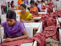 Textile workers making clothing in Bangalore. Many of the workers emigrate from poor regions of the country, making clothes to be sold in th...