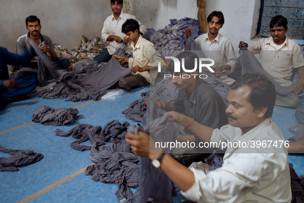 Workers at Swastika Fabrics, a fabric dying factory in Bangalore. Many of the workers emigrate from poor regions of the country, making clot...