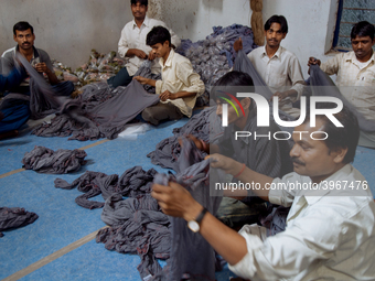 Workers at Swastika Fabrics, a fabric dying factory in Bangalore. Many of the workers emigrate from poor regions of the country, making clot...