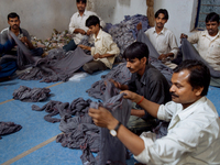 Workers at Swastika Fabrics, a fabric dying factory in Bangalore. Many of the workers emigrate from poor regions of the country, making clot...