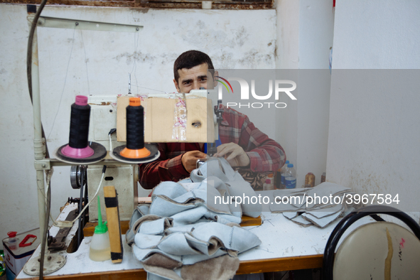 Workers making shoes in a small basement factory in the Zeytinburnu neighborhood of Istanbul, where a mix of immigrant and Turkish workers a...