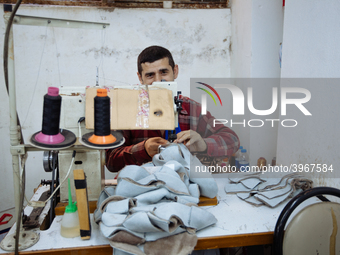 Workers making shoes in a small basement factory in the Zeytinburnu neighborhood of Istanbul, where a mix of immigrant and Turkish workers a...