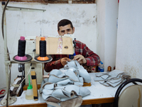 Workers making shoes in a small basement factory in the Zeytinburnu neighborhood of Istanbul, where a mix of immigrant and Turkish workers a...