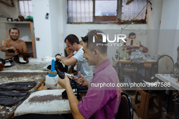 Workers making shoes in a small basement factory in the Zeytinburnu neighborhood of Istanbul, where a mix of immigrant and Turkish workers a...