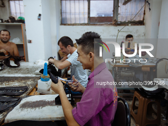 Workers making shoes in a small basement factory in the Zeytinburnu neighborhood of Istanbul, where a mix of immigrant and Turkish workers a...