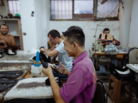 Workers making shoes in a small basement factory in the Zeytinburnu neighborhood of Istanbul, where a mix of immigrant and Turkish workers a...