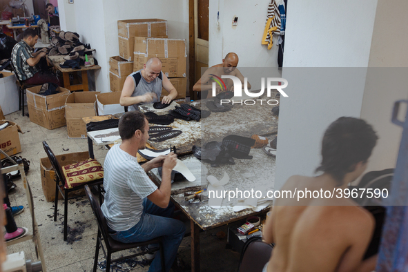 Workers making shoes in a small basement factory in the Zeytinburnu neighborhood of Istanbul, where a mix of immigrant and Turkish workers a...