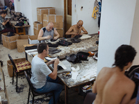 Workers making shoes in a small basement factory in the Zeytinburnu neighborhood of Istanbul, where a mix of immigrant and Turkish workers a...