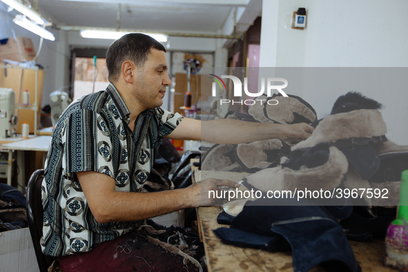 Workers making shoes in a small basement factory in the Zeytinburnu neighborhood of Istanbul, where a mix of immigrant and Turkish workers a...