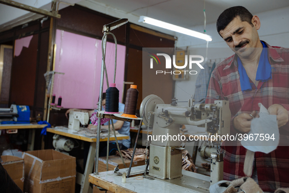 Workers making shoes in a small basement factory in the Zeytinburnu neighborhood of Istanbul, where a mix of immigrant and Turkish workers a...