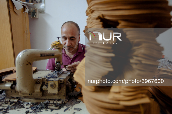 Workers making shoes in a small basement factory in the Zeytinburnu neighborhood of Istanbul, where a mix of immigrant and Turkish workers a...