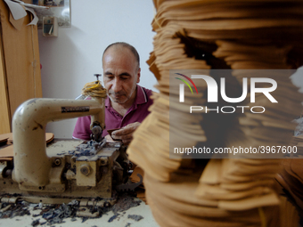 Workers making shoes in a small basement factory in the Zeytinburnu neighborhood of Istanbul, where a mix of immigrant and Turkish workers a...