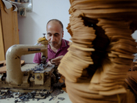 Workers making shoes in a small basement factory in the Zeytinburnu neighborhood of Istanbul, where a mix of immigrant and Turkish workers a...