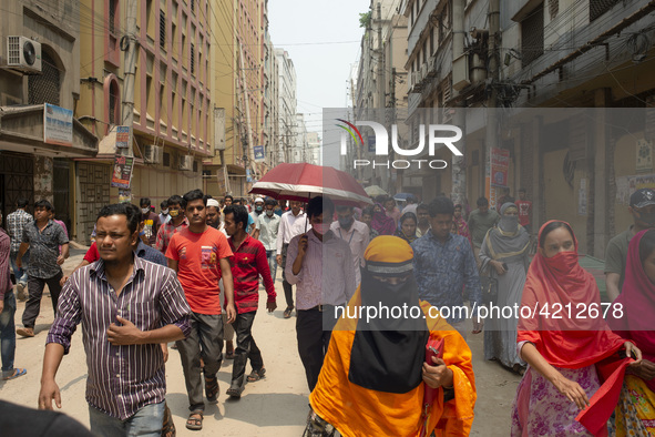 Workers coming out from different garments factories on their way home during lunch break in Narayanganj on April 24, 2019. 