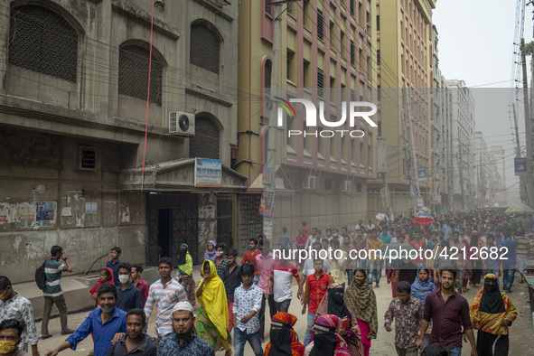 Workers coming out from different garments factories on their way home during lunch break in Narayanganj on April 24, 2019. 