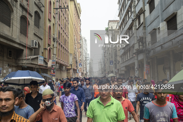 Workers coming out from different garments factories on their way home during lunch break in Narayanganj on April 24, 2019. 