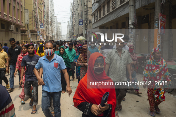 Workers coming out from different garments factories on their way home during lunch break in Narayanganj on April 24, 2019. 