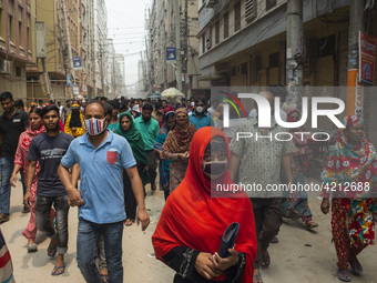 Workers coming out from different garments factories on their way home during lunch break in Narayanganj on April 24, 2019. (