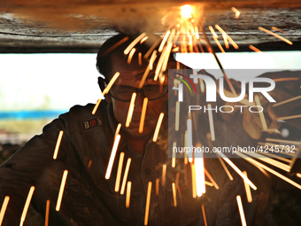 
quid iron is flowing into the prepared propeller mould at a dockyard on the bank of River Buriganga in Dhaka, Bangladesh (