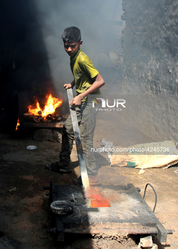 Liquid iron is flowing into the prepared propeller mould at a dockyard on the bank of River Buriganga in Dhaka, Bangladesh 