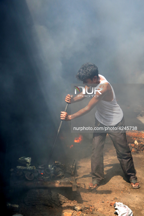 Liquid iron is flowing into the prepared propeller mould at a dockyard on the bank of River Buriganga in Dhaka, Bangladesh 