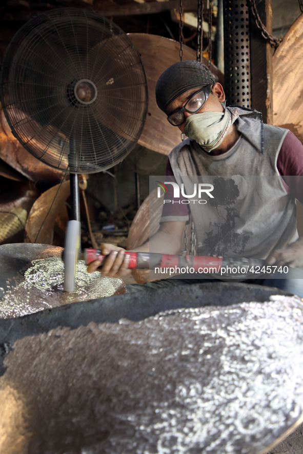  Bangladeshi worker works in a dockyard on the bank of River Buriganga, Dhaka, Bangladesh on 30 April 2019.. 