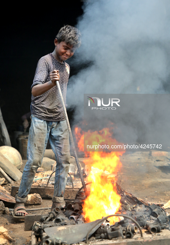 Liquid iron is flowing into the prepared propeller mould at a dockyard on the bank of River Buriganga in Dhaka, Bangladesh 