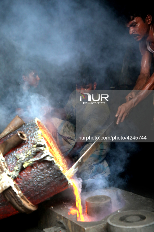 Liquid iron is flowing into the prepared propeller mould at a dockyard on the bank of River Buriganga in Dhaka, Bangladesh 