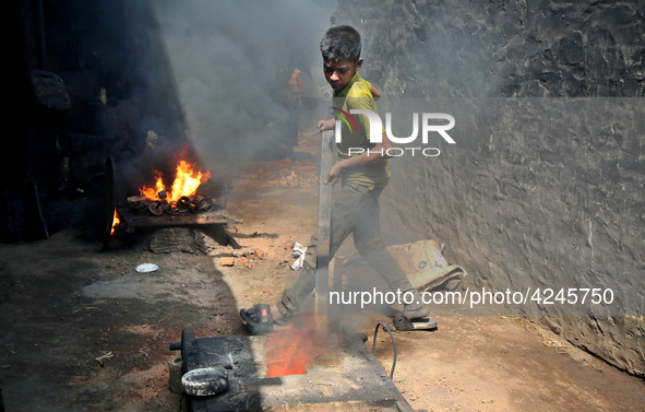 Liquid iron is flowing into the prepared propeller mould at a dockyard on the bank of River Buriganga in Dhaka, Bangladesh 