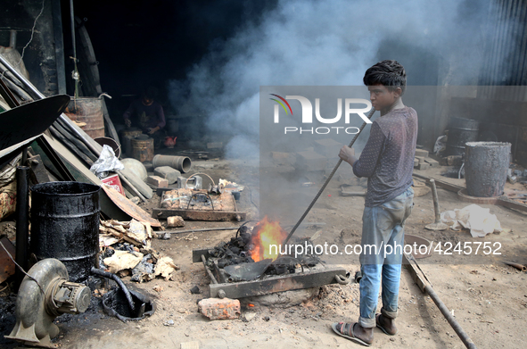 Liquid iron is flowing into the prepared propeller mould at a dockyard on the bank of River Buriganga in Dhaka, Bangladesh 