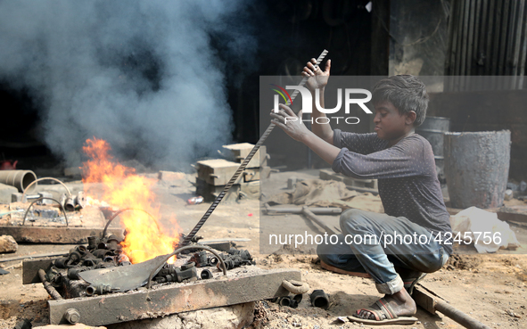 Liquid iron is flowing into the prepared propeller mould at a dockyard on the bank of River Buriganga in Dhaka, Bangladesh 