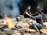 Liquid iron is flowing into the prepared propeller mould at a dockyard on the bank of River Buriganga in Dhaka, Bangladesh (