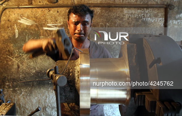  Bangladeshi worker works in a dockyard on the bank of River Buriganga, Dhaka, Bangladesh on 30 April 2019.. 