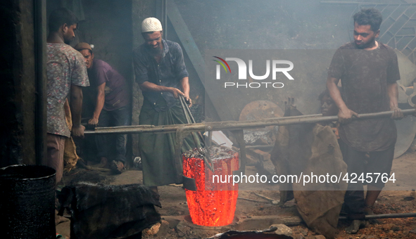 Liquid iron is flowing into the prepared propeller mould at a dockyard on the bank of River Buriganga in Dhaka, Bangladesh 