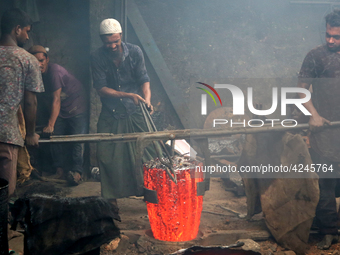 Liquid iron is flowing into the prepared propeller mould at a dockyard on the bank of River Buriganga in Dhaka, Bangladesh (