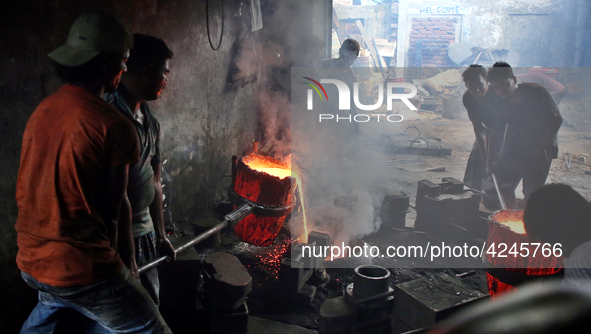 Liquid iron is flowing into the prepared propeller mould at a dockyard on the bank of River Buriganga in Dhaka, Bangladesh 