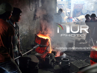 Liquid iron is flowing into the prepared propeller mould at a dockyard on the bank of River Buriganga in Dhaka, Bangladesh (