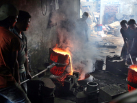 Liquid iron is flowing into the prepared propeller mould at a dockyard on the bank of River Buriganga in Dhaka, Bangladesh (