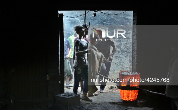 Liquid iron is flowing into the prepared propeller mould at a dockyard on the bank of River Buriganga in Dhaka, Bangladesh 