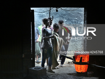 Liquid iron is flowing into the prepared propeller mould at a dockyard on the bank of River Buriganga in Dhaka, Bangladesh (