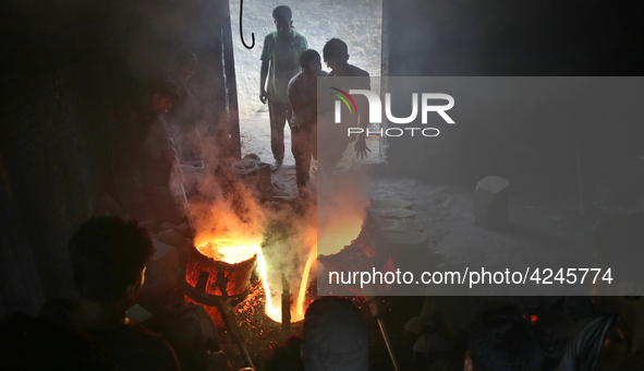 Liquid iron is flowing into the prepared propeller mould at a dockyard on the bank of River Buriganga in Dhaka, Bangladesh 