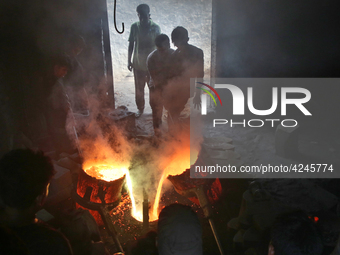 Liquid iron is flowing into the prepared propeller mould at a dockyard on the bank of River Buriganga in Dhaka, Bangladesh (